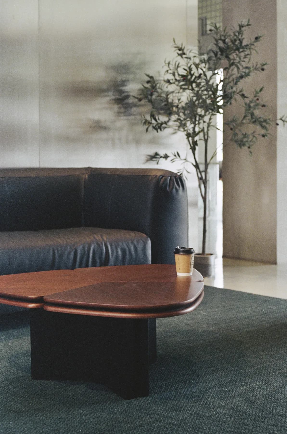Clover coffee table with paired wood-look tops in a lounge